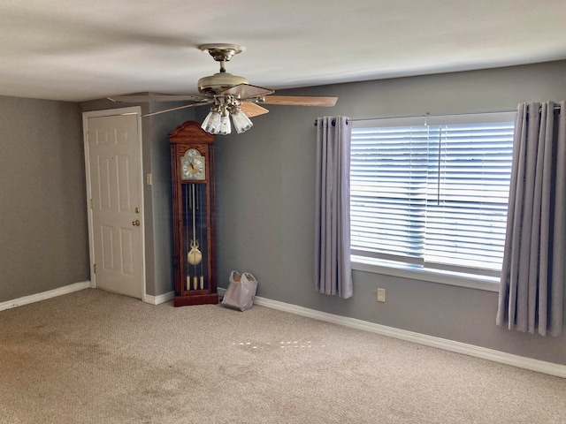 empty room with light colored carpet and ceiling fan