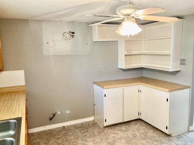 kitchen featuring white cabinets and ceiling fan