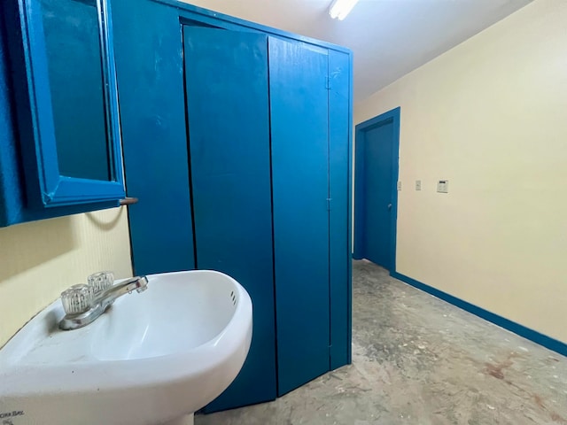 bathroom with sink and concrete floors