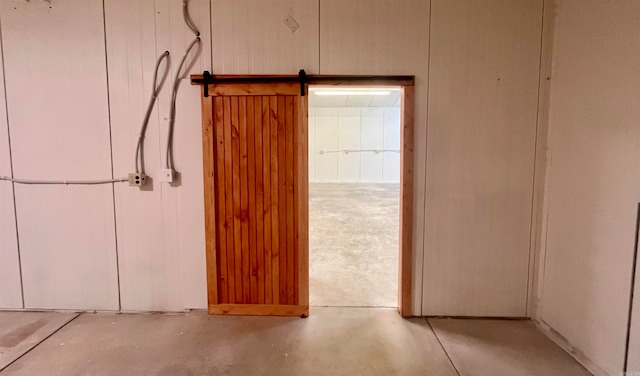 interior space featuring a barn door and concrete flooring