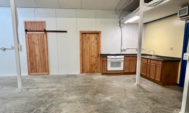 interior space featuring sink, white range, and a barn door