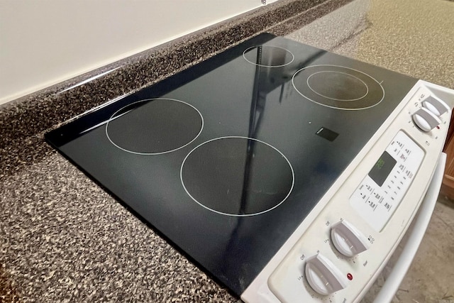 room details featuring dark stone countertops and range