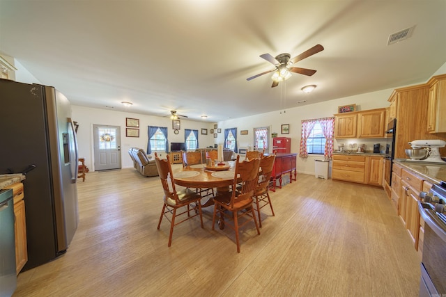 dining space featuring ceiling fan and light hardwood / wood-style flooring