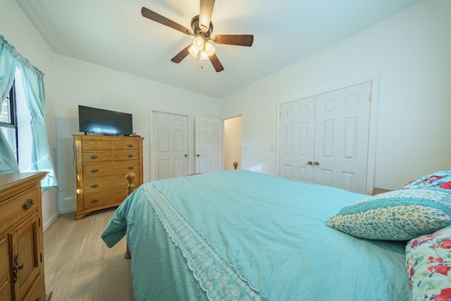 bedroom with light hardwood / wood-style floors and ceiling fan