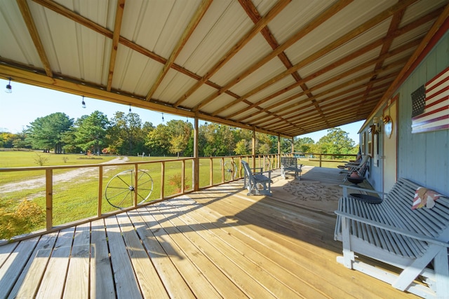 wooden terrace featuring a lawn