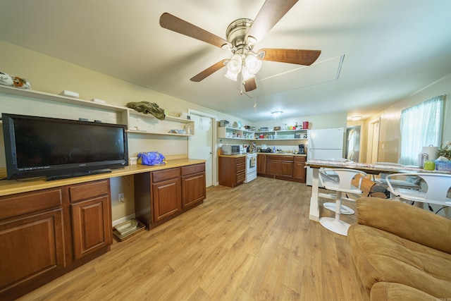 kitchen featuring ceiling fan, light hardwood / wood-style flooring, and white appliances