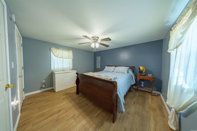 10 Strawberry Valley Rd, Ash Flat, AR 72513 - bedroom with baseboards, a ceiling fan, multiple windows, and light wood-style flooring
