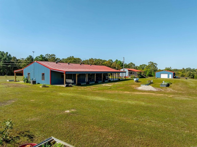 view of yard featuring central AC unit and an outbuilding