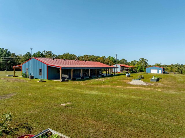10 Strawberry Valley Rd, Ash Flat, AR 72513 - rear view of house with a lawn, an outbuilding, central AC unit, and metal roof