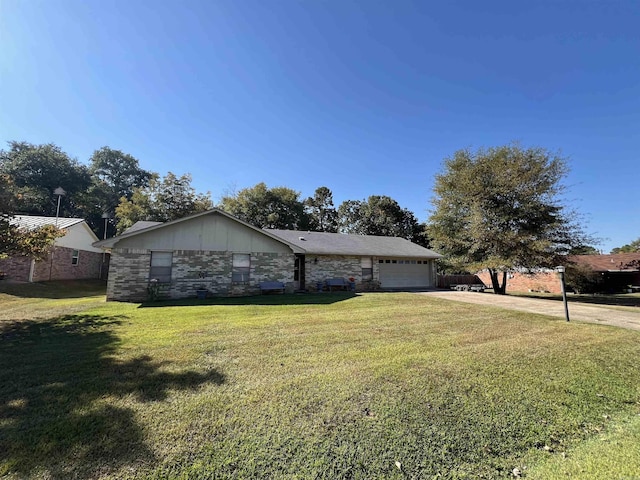 single story home featuring a garage and a front yard