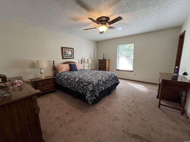 bedroom featuring carpet floors, a textured ceiling, and ceiling fan