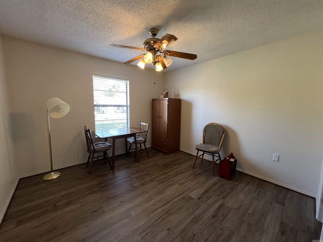 unfurnished room with ceiling fan, a textured ceiling, and dark hardwood / wood-style flooring