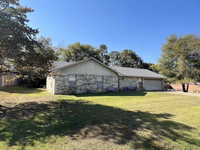 ranch-style home with a front lawn and a garage