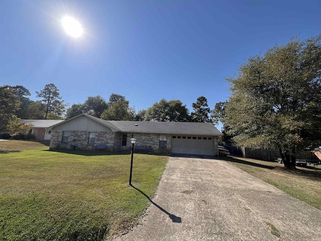 ranch-style home featuring a garage and a front lawn