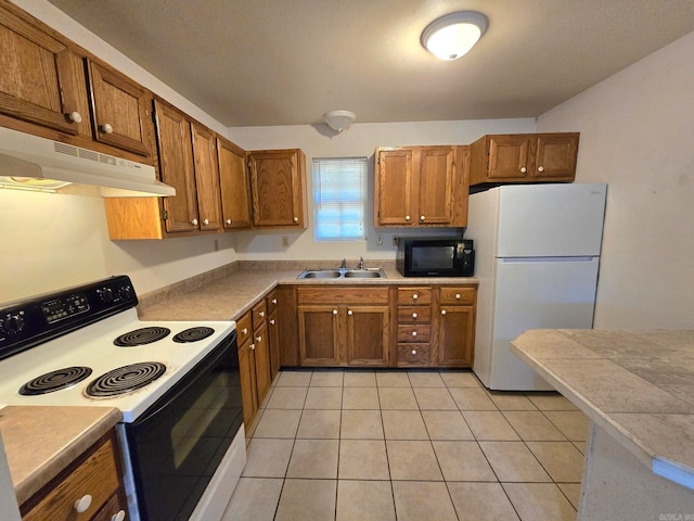 kitchen with light tile patterned flooring, white appliances, and sink