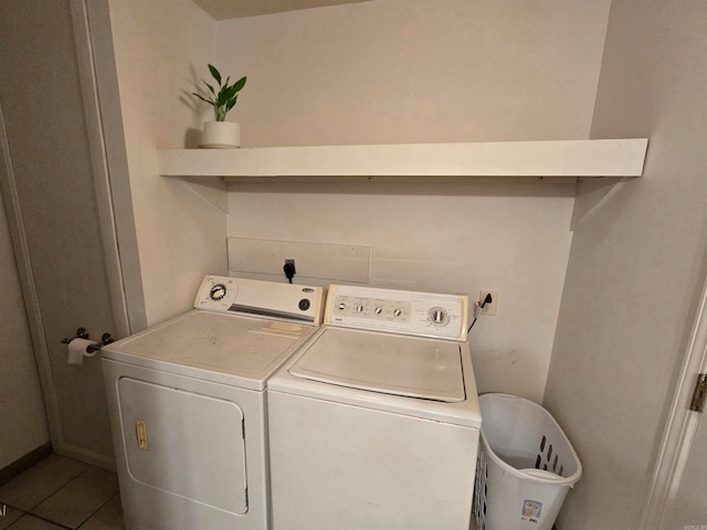 laundry room featuring washing machine and dryer and tile patterned flooring