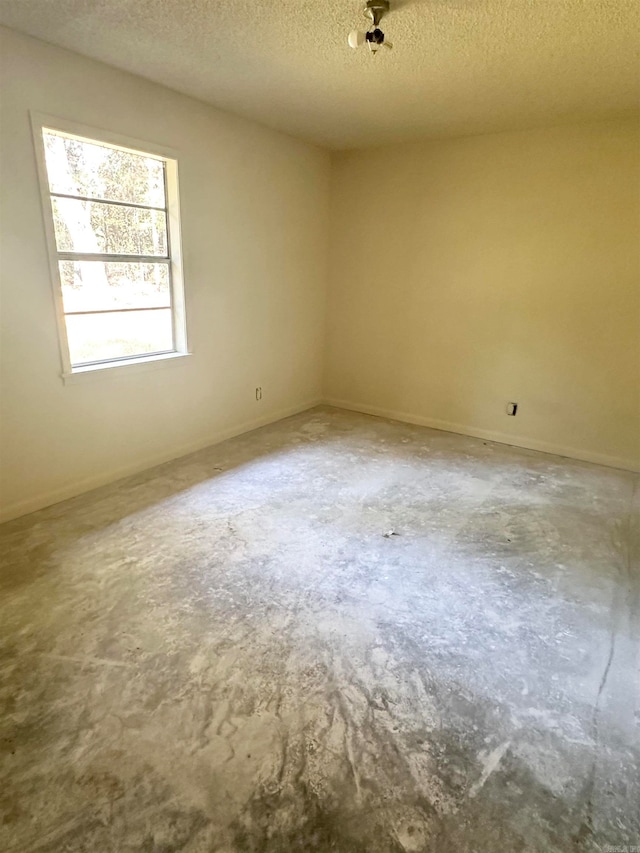 spare room with a textured ceiling