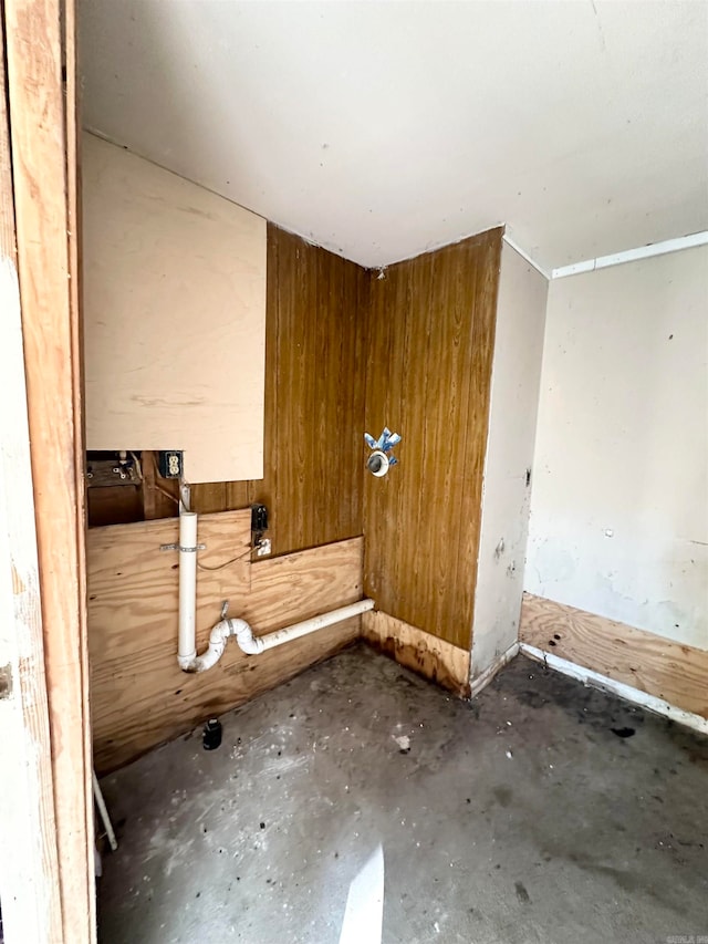 interior space with wooden walls and concrete flooring