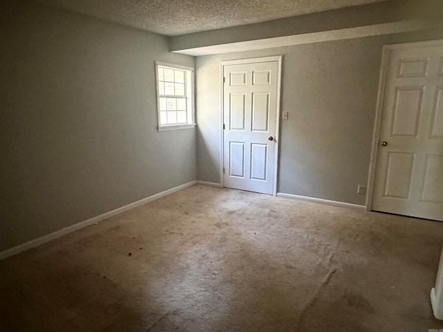 unfurnished bedroom featuring carpet floors and a textured ceiling