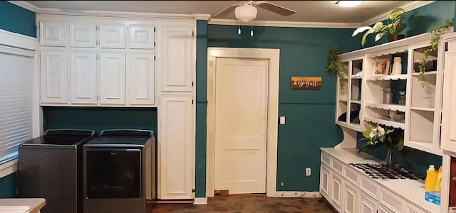 laundry area with ceiling fan, crown molding, washing machine and clothes dryer, and cabinets