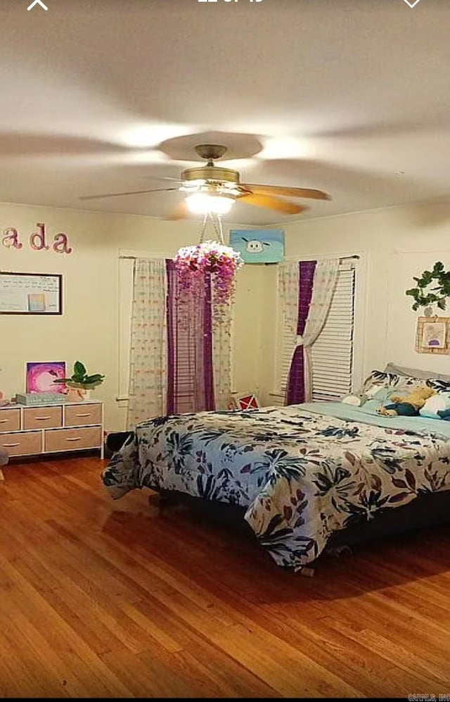 bedroom with hardwood / wood-style flooring and ceiling fan