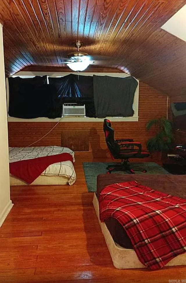 bedroom with hardwood / wood-style flooring, vaulted ceiling, and wood ceiling