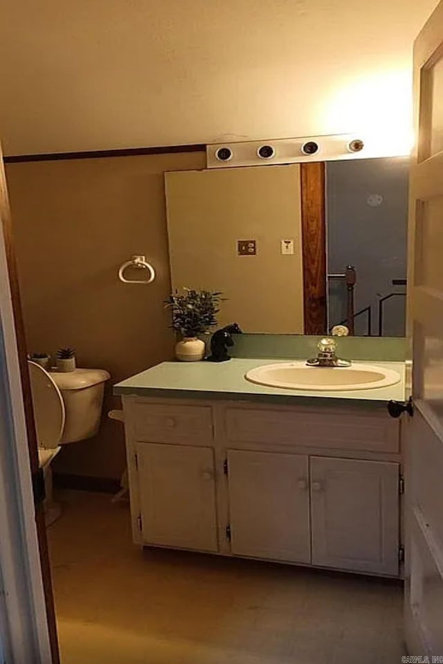 bathroom featuring vanity and toilet