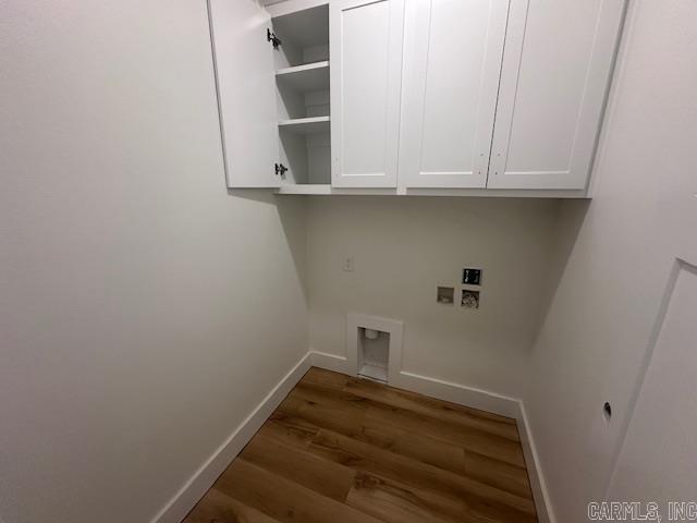 laundry room featuring cabinets, washer hookup, and dark hardwood / wood-style flooring