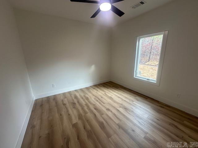 empty room featuring ceiling fan and light wood-type flooring