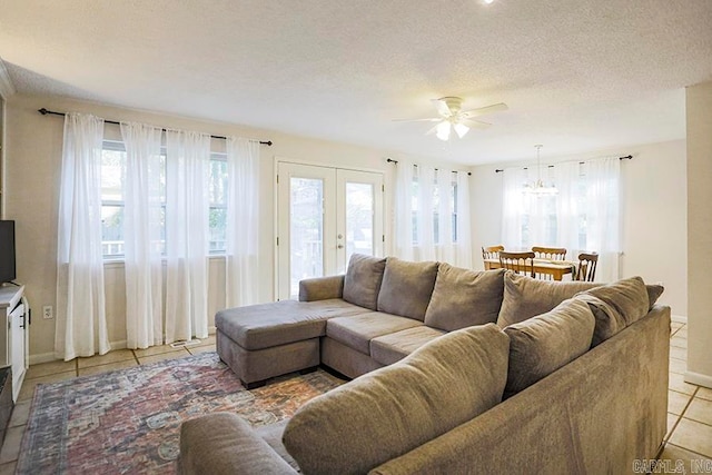 tiled living room featuring ceiling fan and a textured ceiling