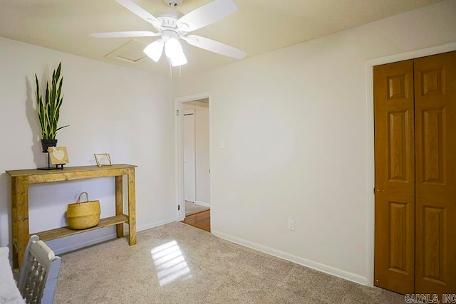 interior space featuring ceiling fan and light carpet