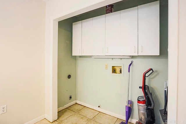 laundry room featuring light tile patterned flooring, hookup for a washing machine, and cabinets