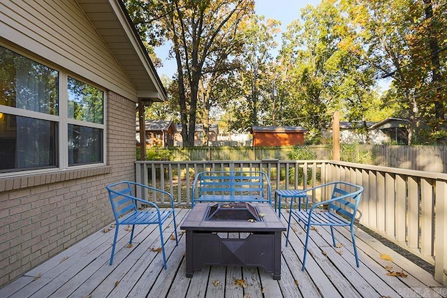 wooden deck featuring a fire pit