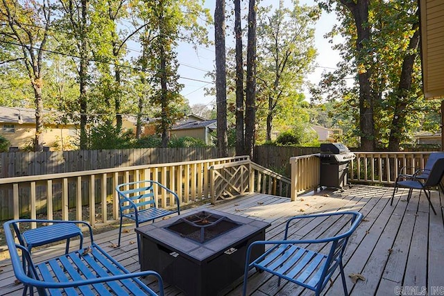 deck with an outdoor fire pit and area for grilling