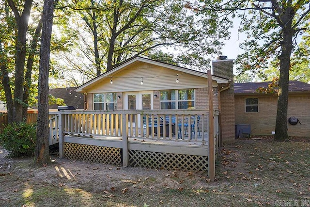 rear view of property featuring a deck