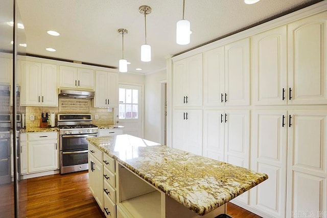 kitchen with a kitchen island, dark hardwood / wood-style floors, stainless steel gas stove, ornamental molding, and decorative light fixtures