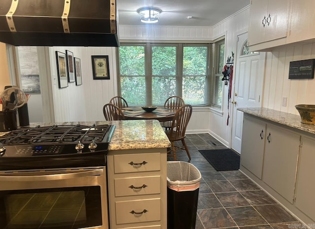 kitchen featuring extractor fan, light stone countertops, crown molding, and gas range