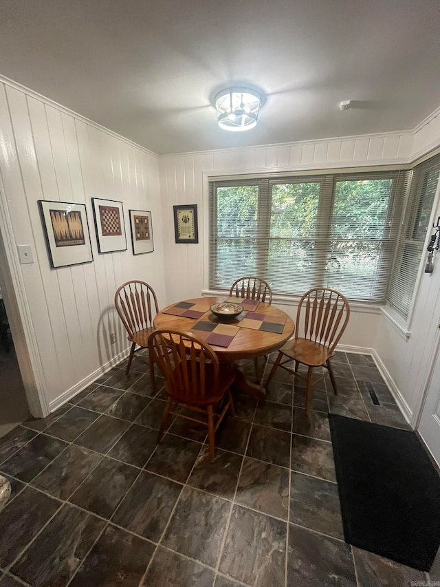 dining area with wooden walls