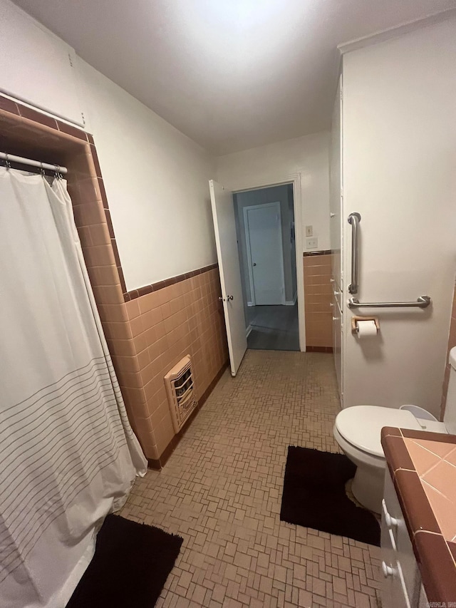 bathroom with vanity, tile walls, and toilet