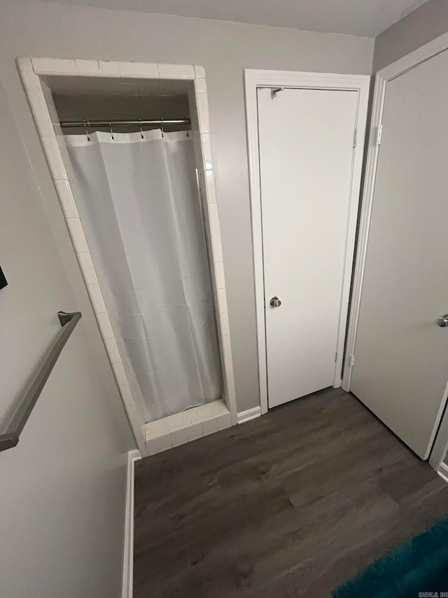 bathroom featuring walk in shower and hardwood / wood-style floors