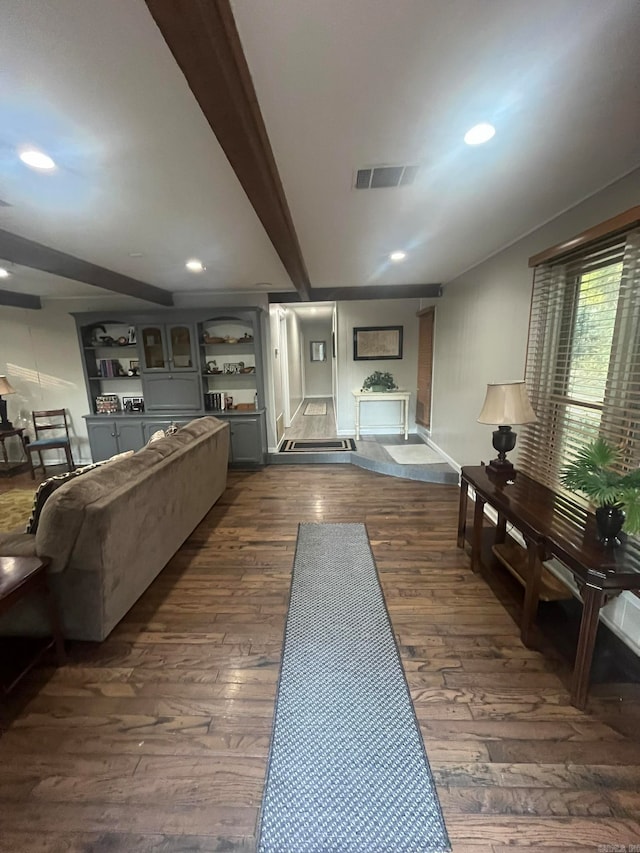 living room with beam ceiling and dark hardwood / wood-style flooring