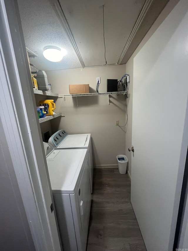 washroom featuring dark wood-type flooring, separate washer and dryer, and a textured ceiling