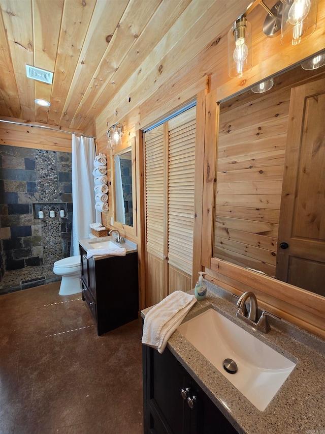 bathroom with vanity, wood walls, toilet, and curtained shower