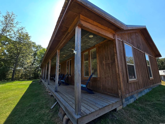 view of side of property with a yard and a deck