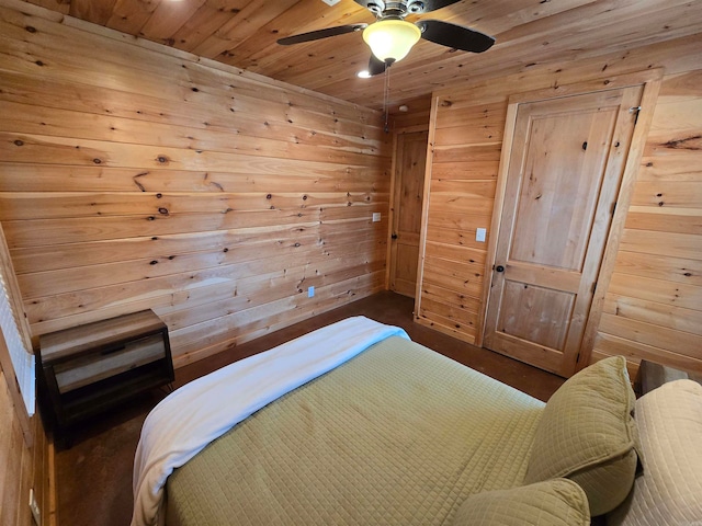 bedroom with wooden ceiling, wooden walls, and ceiling fan