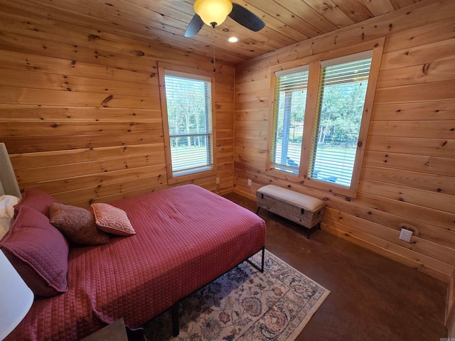 bedroom featuring wooden ceiling, wooden walls, multiple windows, and ceiling fan