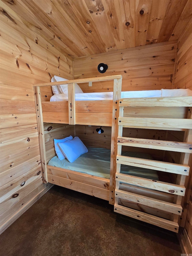 unfurnished bedroom featuring wood ceiling and wood walls