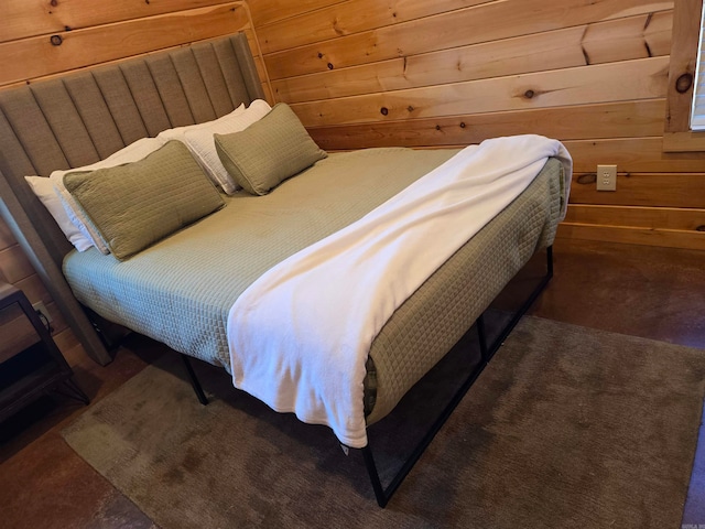 bedroom with wooden walls and carpet