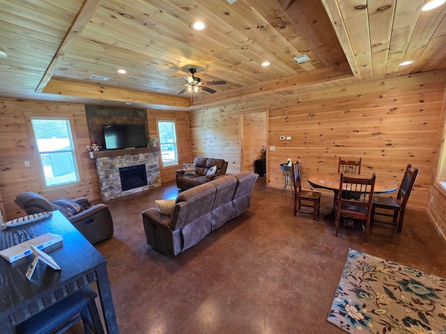 living room with ceiling fan, a stone fireplace, wooden walls, and wooden ceiling