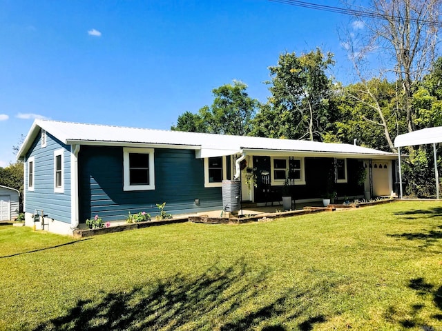 ranch-style home featuring covered porch and a front lawn